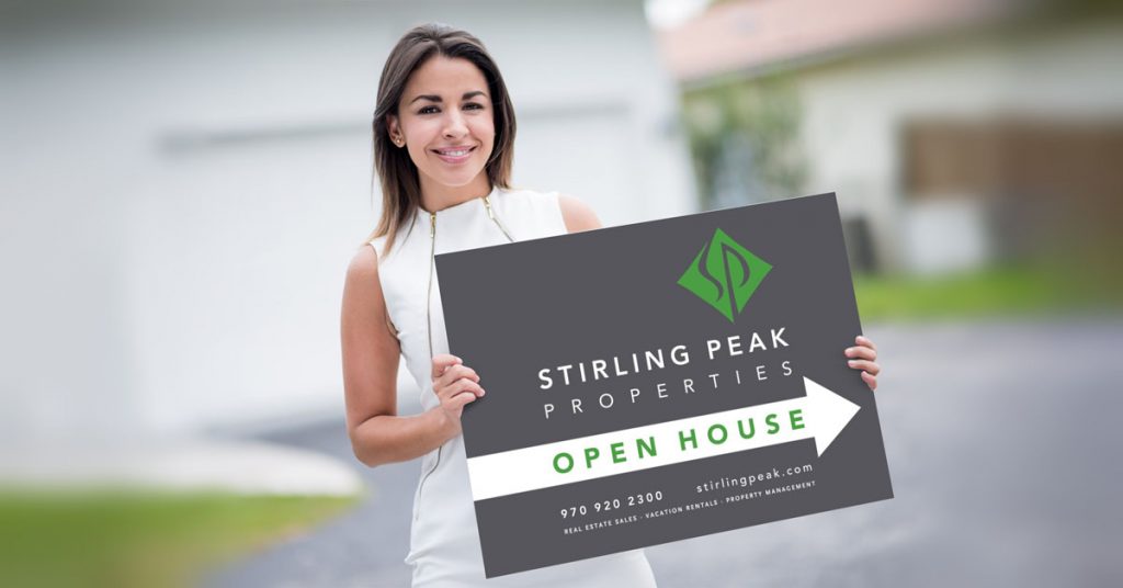 Woman holding custom real estate sign