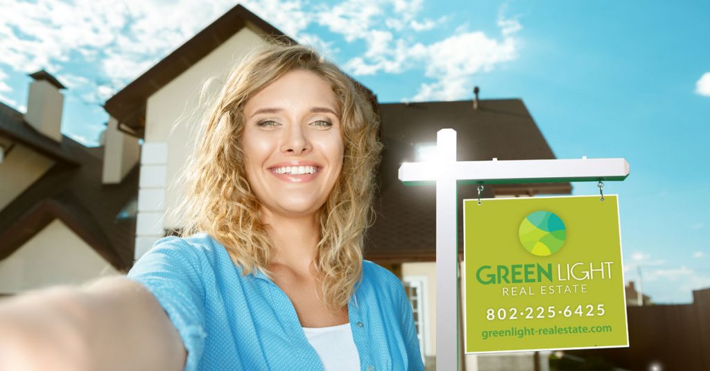 Women with real estate hanging sign